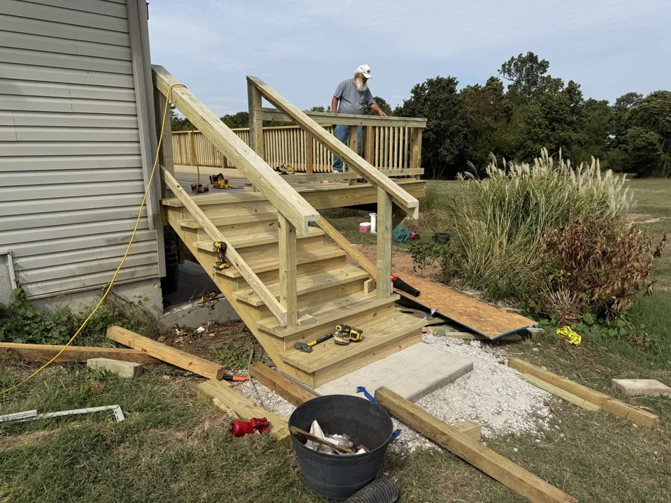 New stair treads and handrail framing during construction.